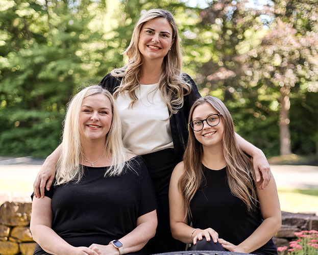 three women happily posing